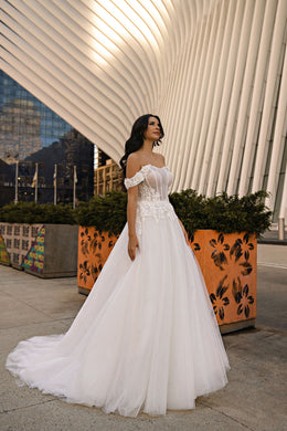 Ivory A-line wedding dress with off-the-shoulder sleeves, floral appliqués, sparkle, and a long train