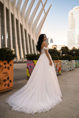 Ivory wedding dress with an elegant A-line skirt, off-the-shoulder sleeves, and a sweeping train