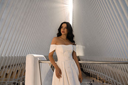 Ivory wedding dress featuring an off-the-shoulder neckline and a close-up view of its sparkling embellished bodice