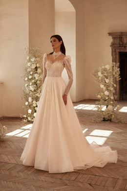 Ivory A-line wedding dress with a beaded illusion high neckline, long sheer sleeves, and a full skirt