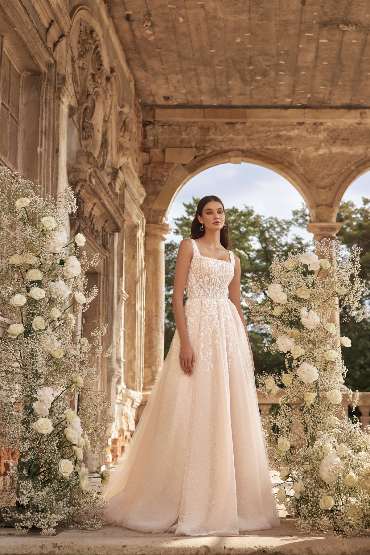 Ivory A-line wedding dress with a square neckline, embellished bodice, and full flowing skirt