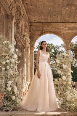 Ivory A-line wedding dress with a square neckline, embellished bodice, and full flowing skirt
