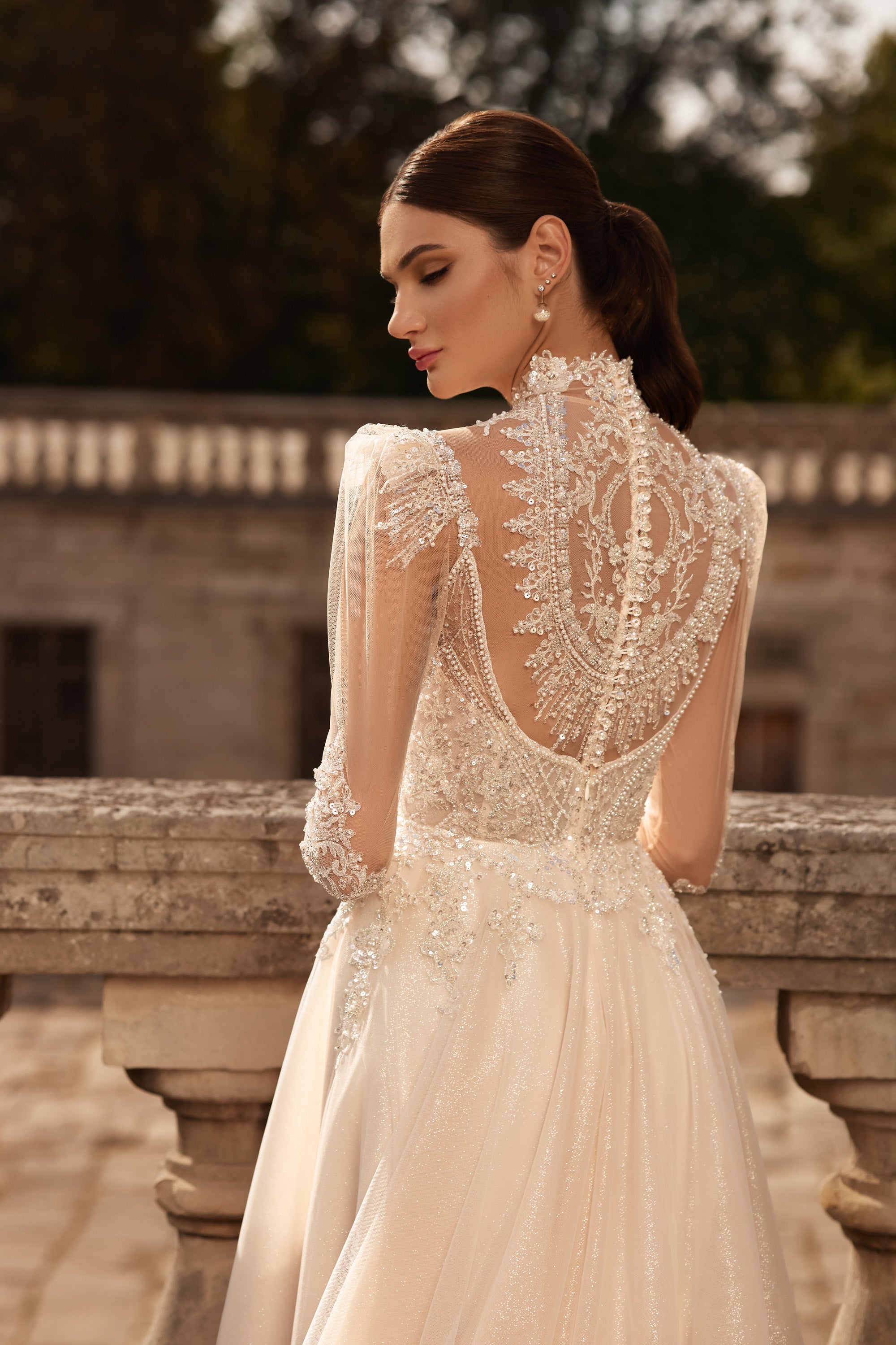 Close-up of an open illusion lace back and high neck on an ivory wedding dress