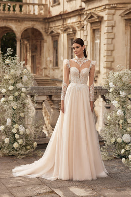 Ivory A-line wedding dress with a beaded bodice, sheer lace sleeves, V-neckline, and sweeping train