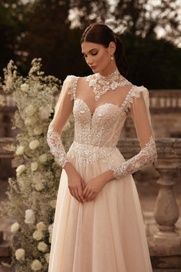 Beaded ivory wedding dress with a sheer illusion neckline, long lace sleeves, and A-line skirt
