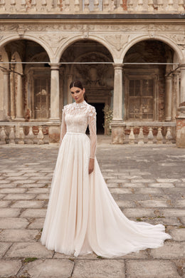 Ivory A-line wedding dress with a high illusion neckline, long lace sleeves, embellished bodice, and long train