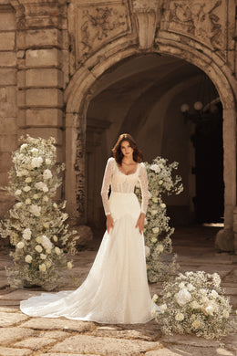 Ivory mermaid wedding dress with long lace sleeves, a scoop neckline, and a sweeping train
