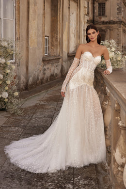 Ivory mermaid wedding dress with a sweetheart neckline, long lace sleeves, sparkling embroidery, and sweeping train
