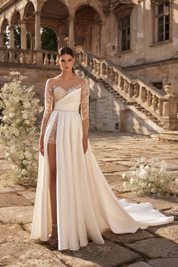 Ivory wedding dress with asymmetric draped bodice, sheer lace sleeves, high slit, and train