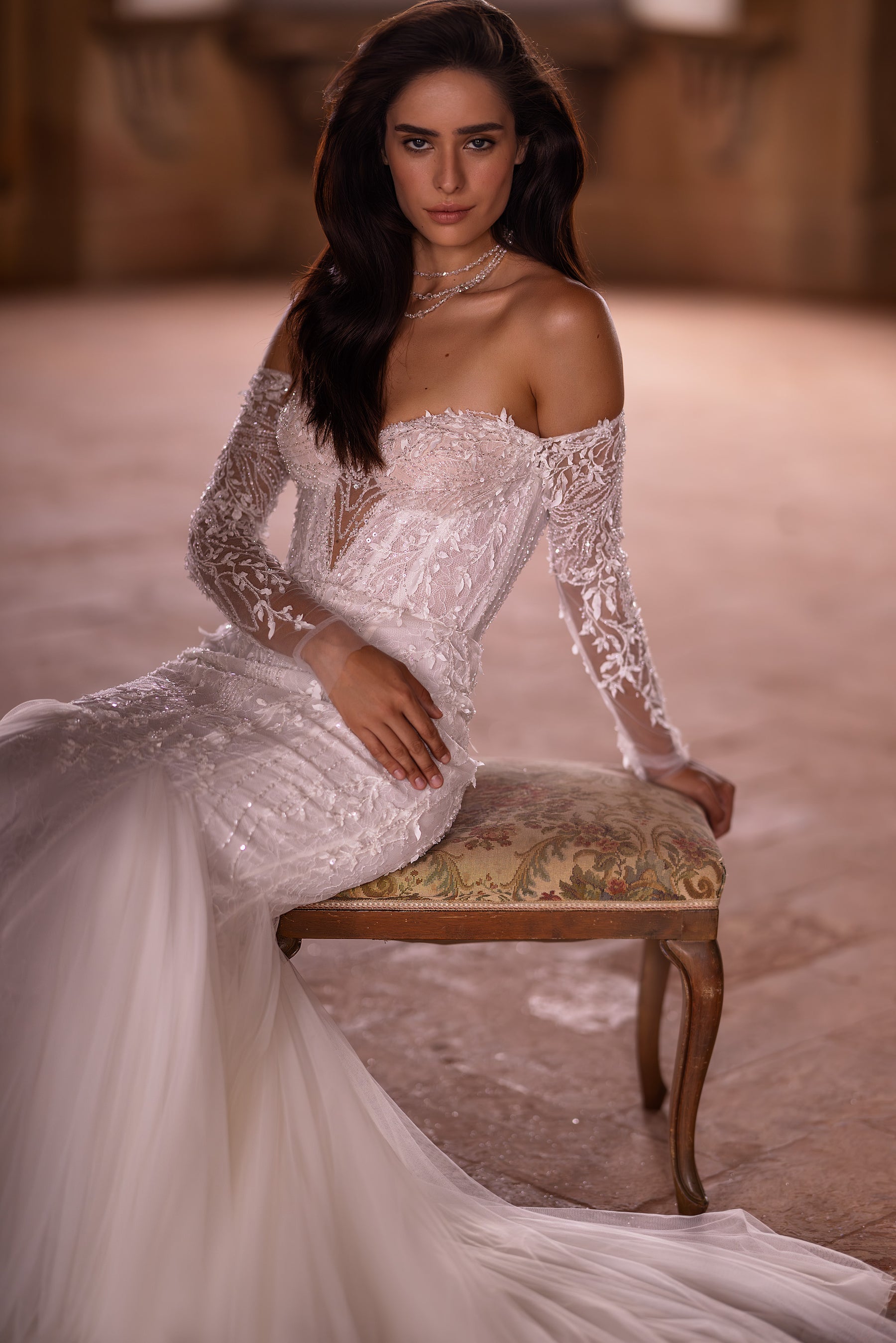 Ivory wedding dress with an off-the-shoulder sweetheart neckline, floral lace bodice, and mermaid train