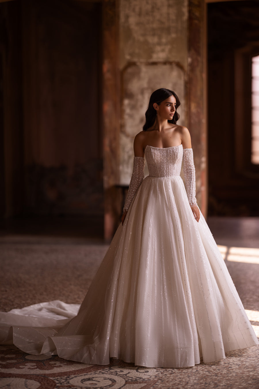 Ivory ball gown wedding dress with beaded off-the-shoulder sleeves, fitted bodice, and long train
