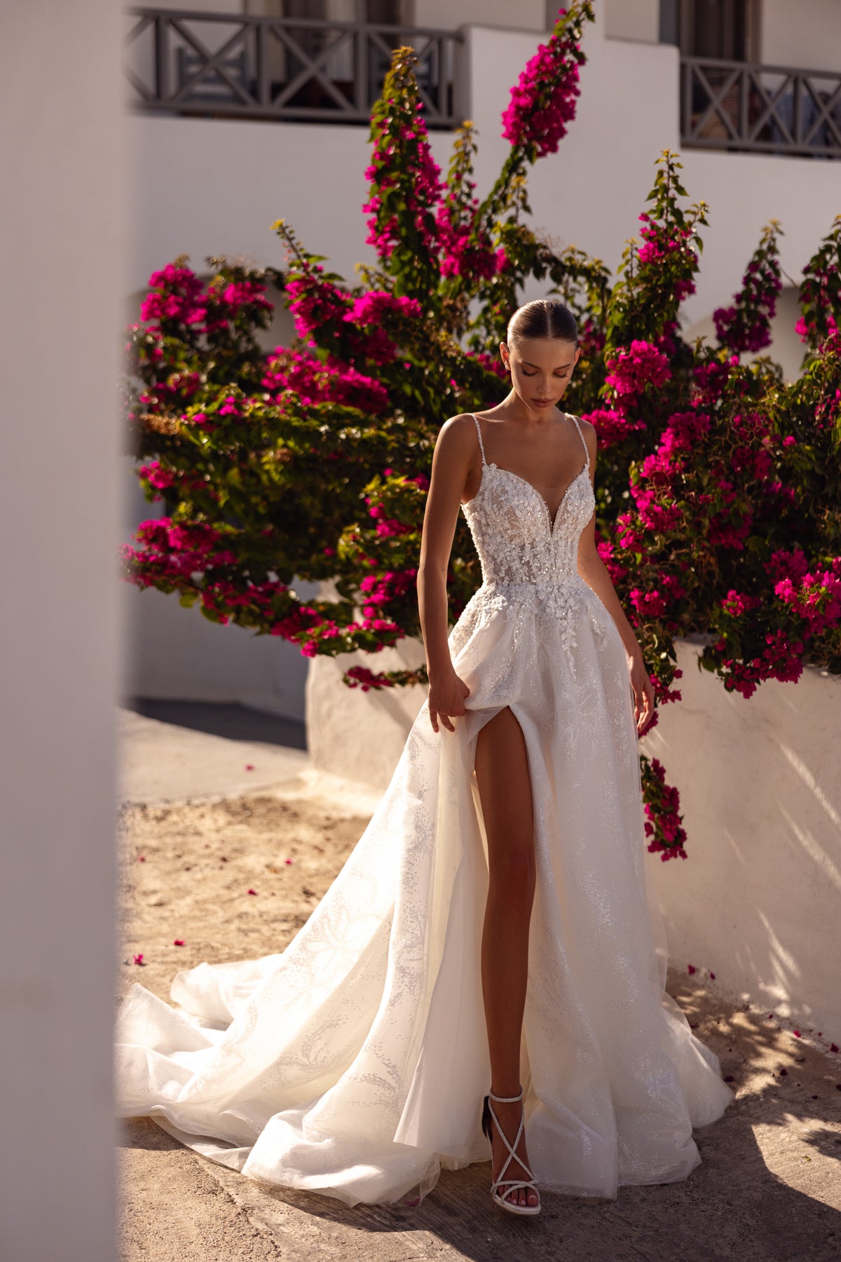 Ivory A-line wedding dress with beaded floral bodice, thin straps, thigh-high slit, and long train
