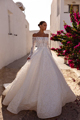 Ivory ball gown wedding dress with an off-the-shoulder neckline, long lace sleeves, and full lace skirt
