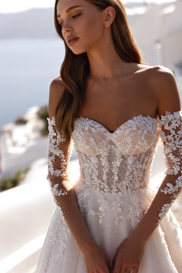 Ivory wedding dress with a sweetheart neckline, off-shoulder sheer lace sleeves, and an embellished floral-lace bodice