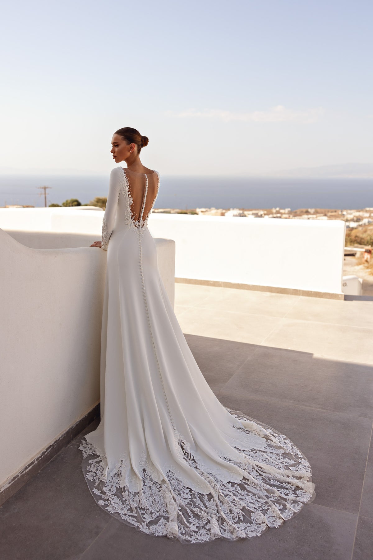 Illusion-back ivory wedding dress with a sweeping train finished in floral lace