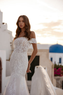 Ivory mermaid wedding dress with an off-the-shoulder neckline and allover sparkling lace