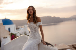 Ivory mermaid wedding dress featuring a beaded lace bodice and off-the-shoulder short sleeves