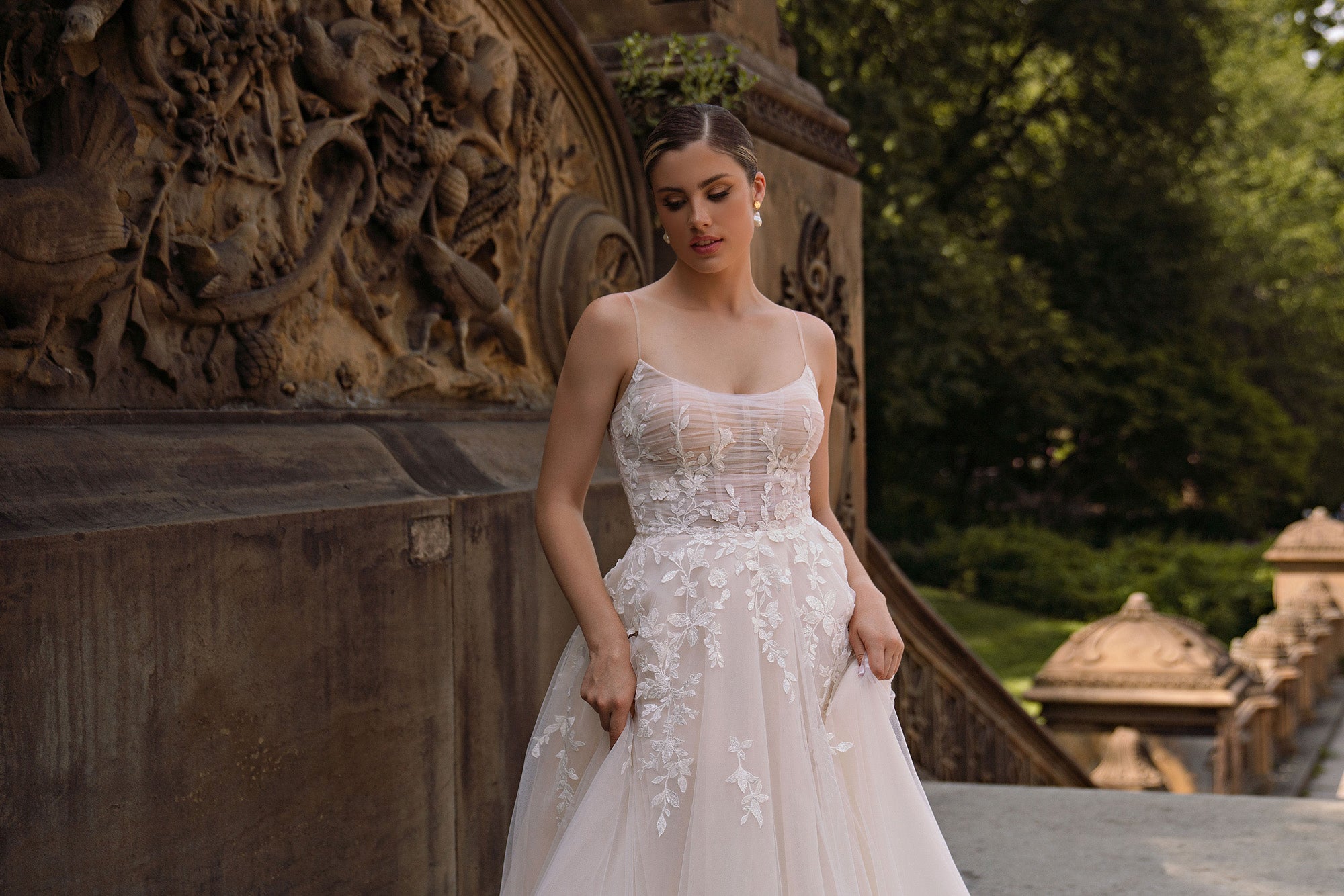 Close-up of floral appliqués and sparkling beadwork on the bodice of an ivory wedding dress