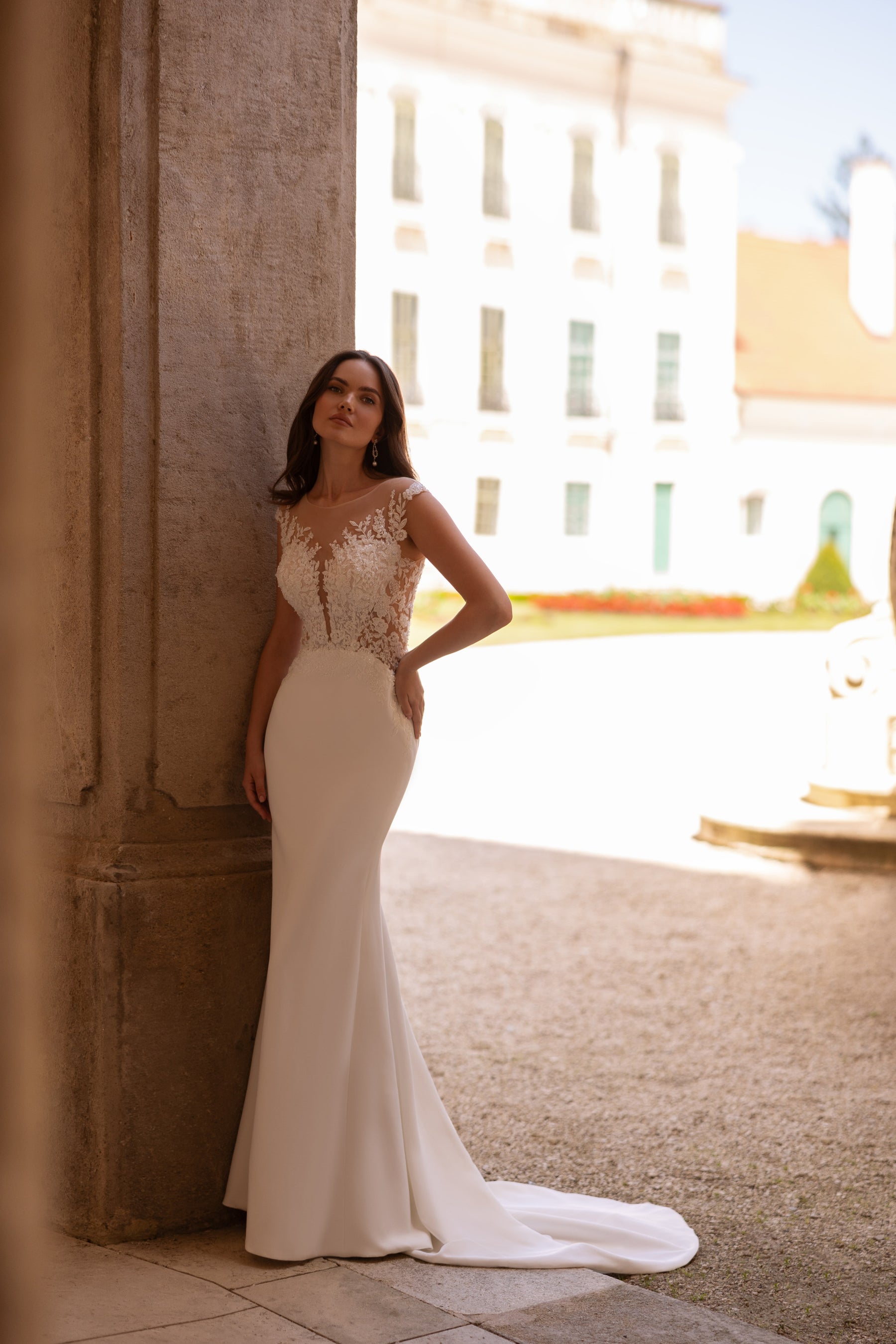 Ivory sheath wedding dress with an illusion lace bodice and sweeping train