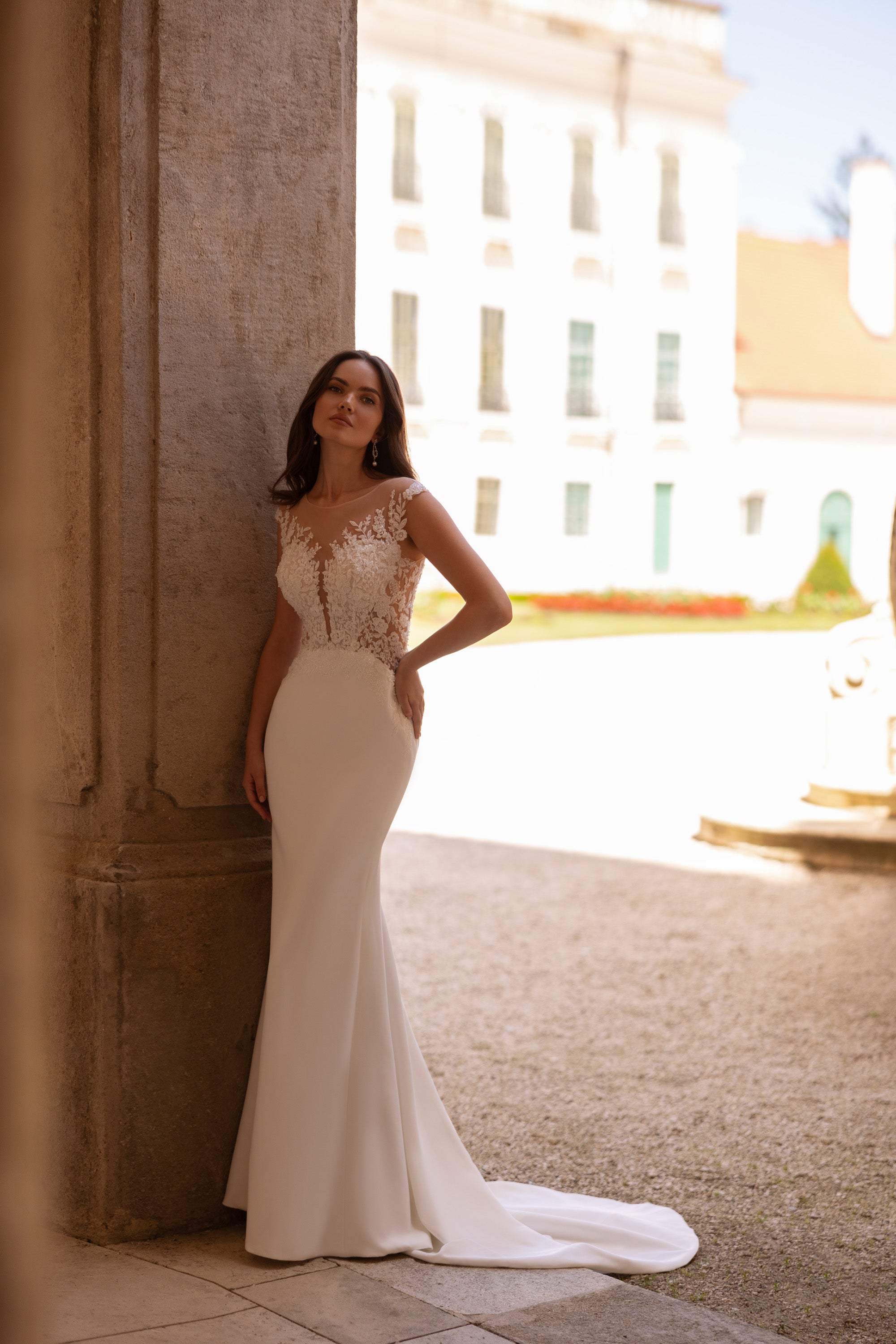 Ivory sheath wedding dress with an illusion lace bodice and sweeping train