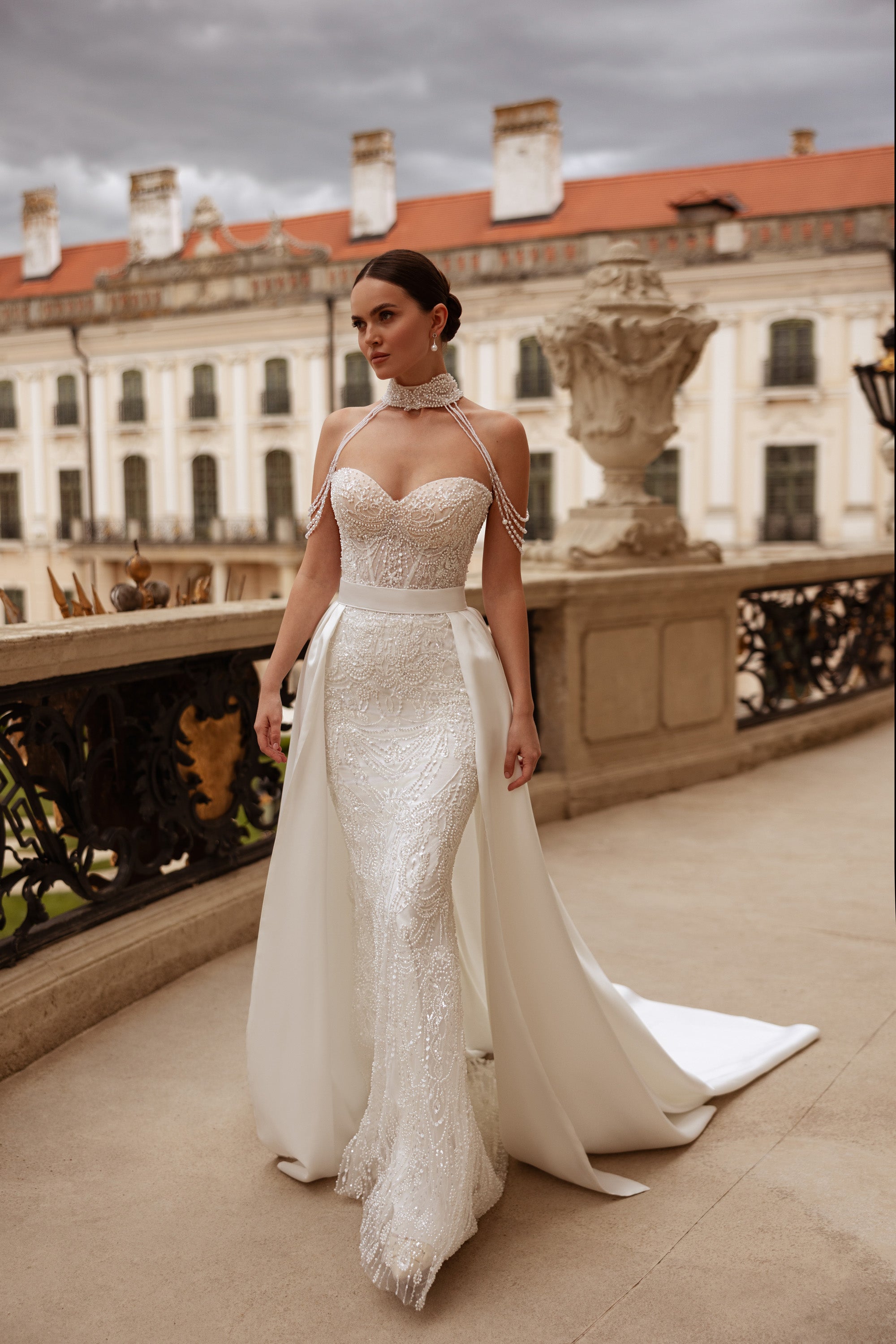Beaded ivory wedding dress with a sweetheart neckline, fitted sheath silhouette, and detachable overskirt