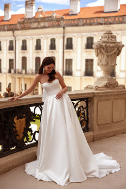 Ivory strapless wedding dress with a beaded sweetheart bodice, full skirt, and sweeping train