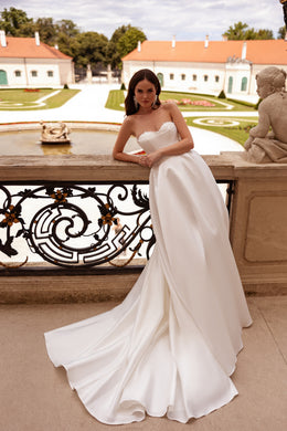Ivory strapless wedding dress featuring a beaded sweetheart neckline and a smooth, full-length skirt
