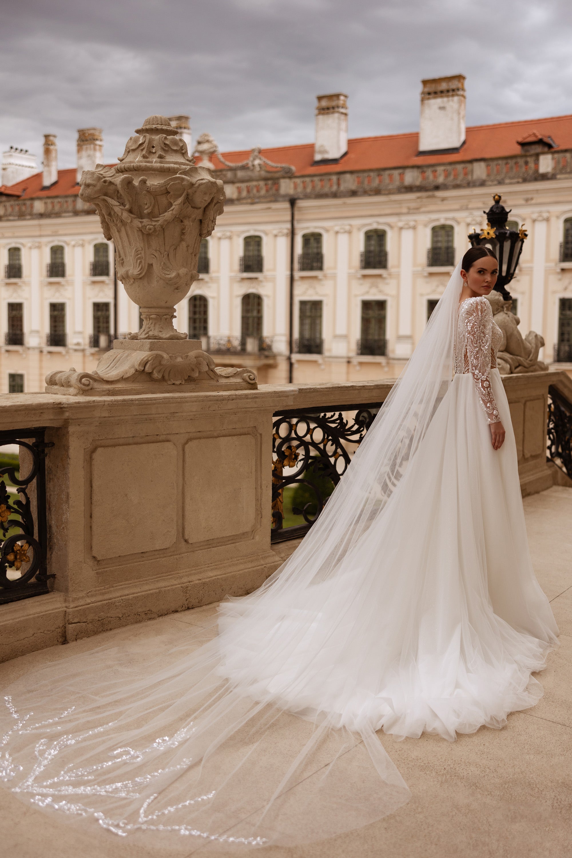 Ivory wedding dress with long illusion lace sleeves and an extra-long sheer train