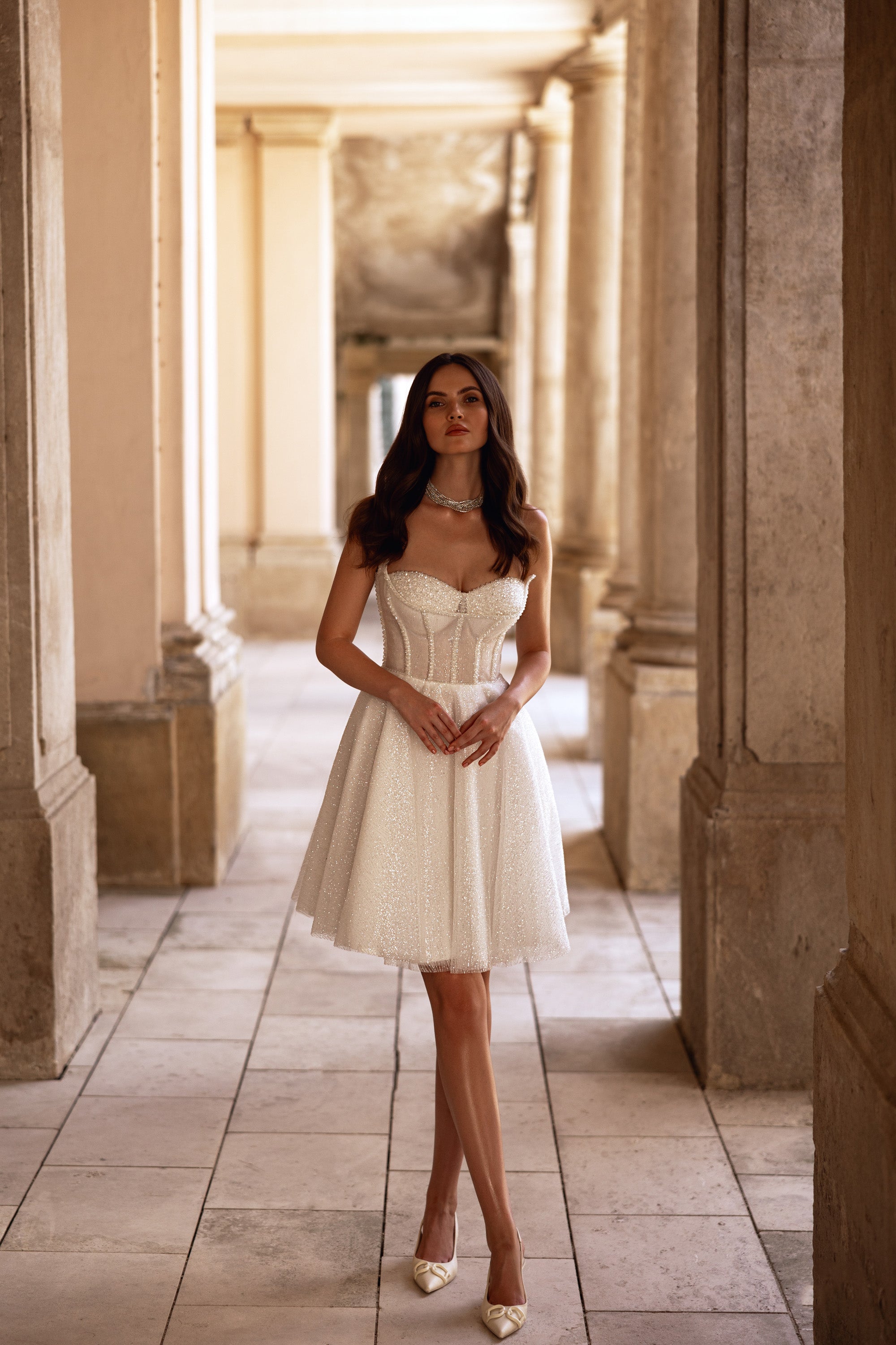 Ivory strapless sweetheart wedding dress with a beaded corset bodice and tea-length A-line skirt