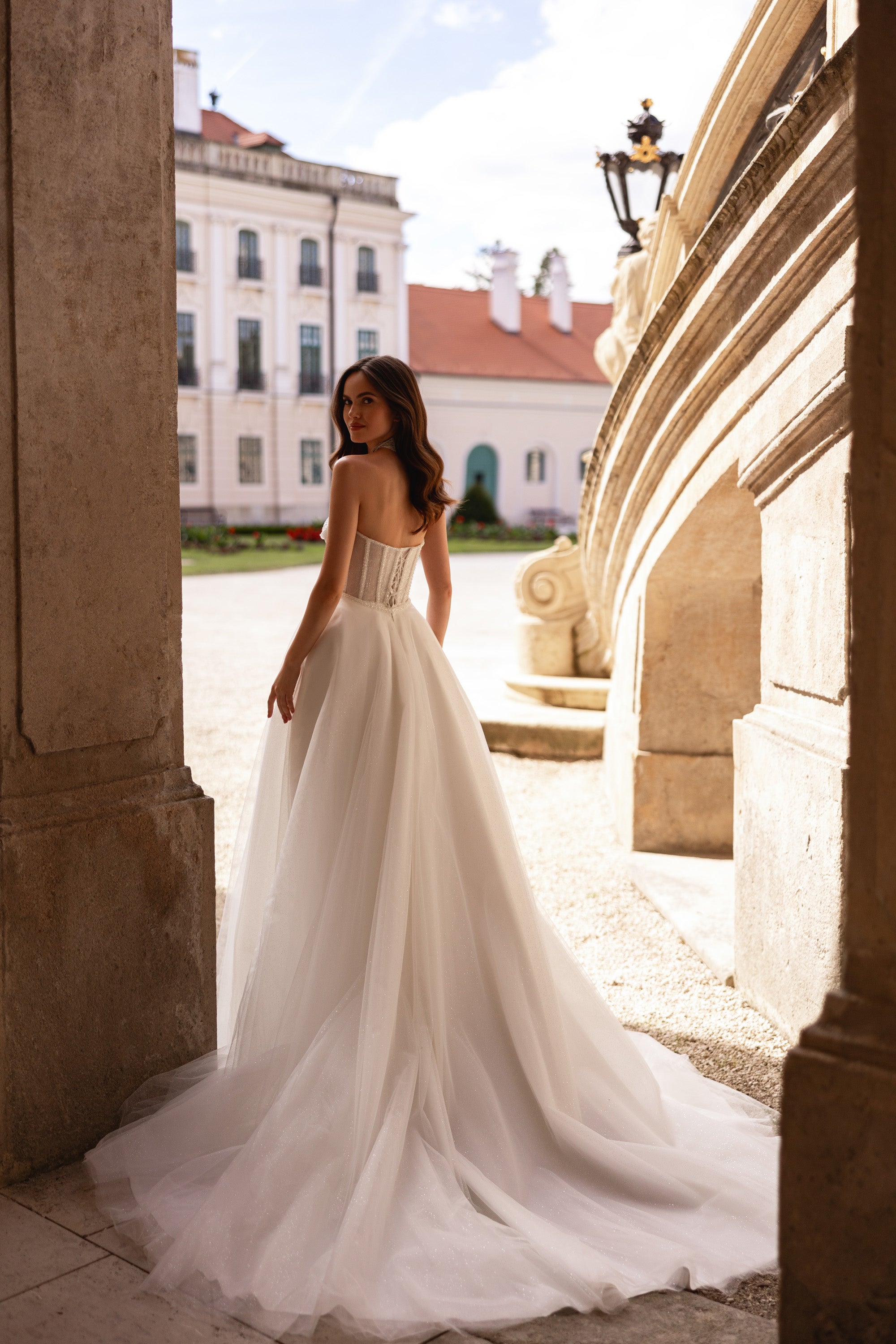 Ivory wedding dress with a corset back, full tulle skirt, and sweeping floor-length train