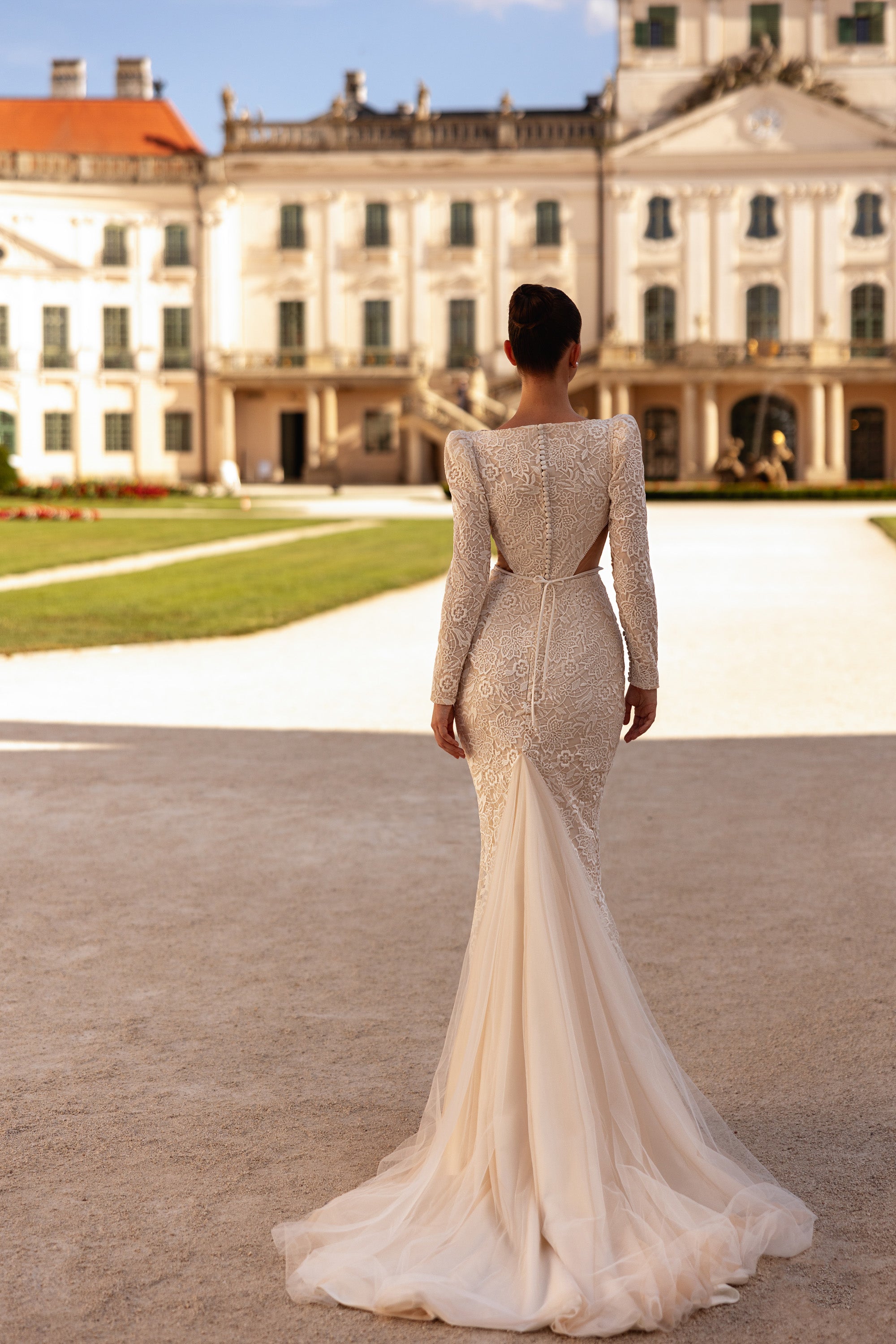 Ivory wedding dress with a lace back, mermaid silhouette, and long sheer tulle train