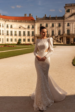 Long-sleeve ivory lace wedding dress with a fitted mermaid skirt and trailing train