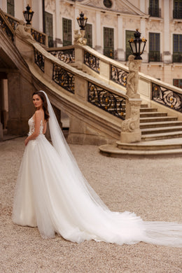 Ivory A-line wedding dress with a full tulle skirt and sweeping chapel-length train