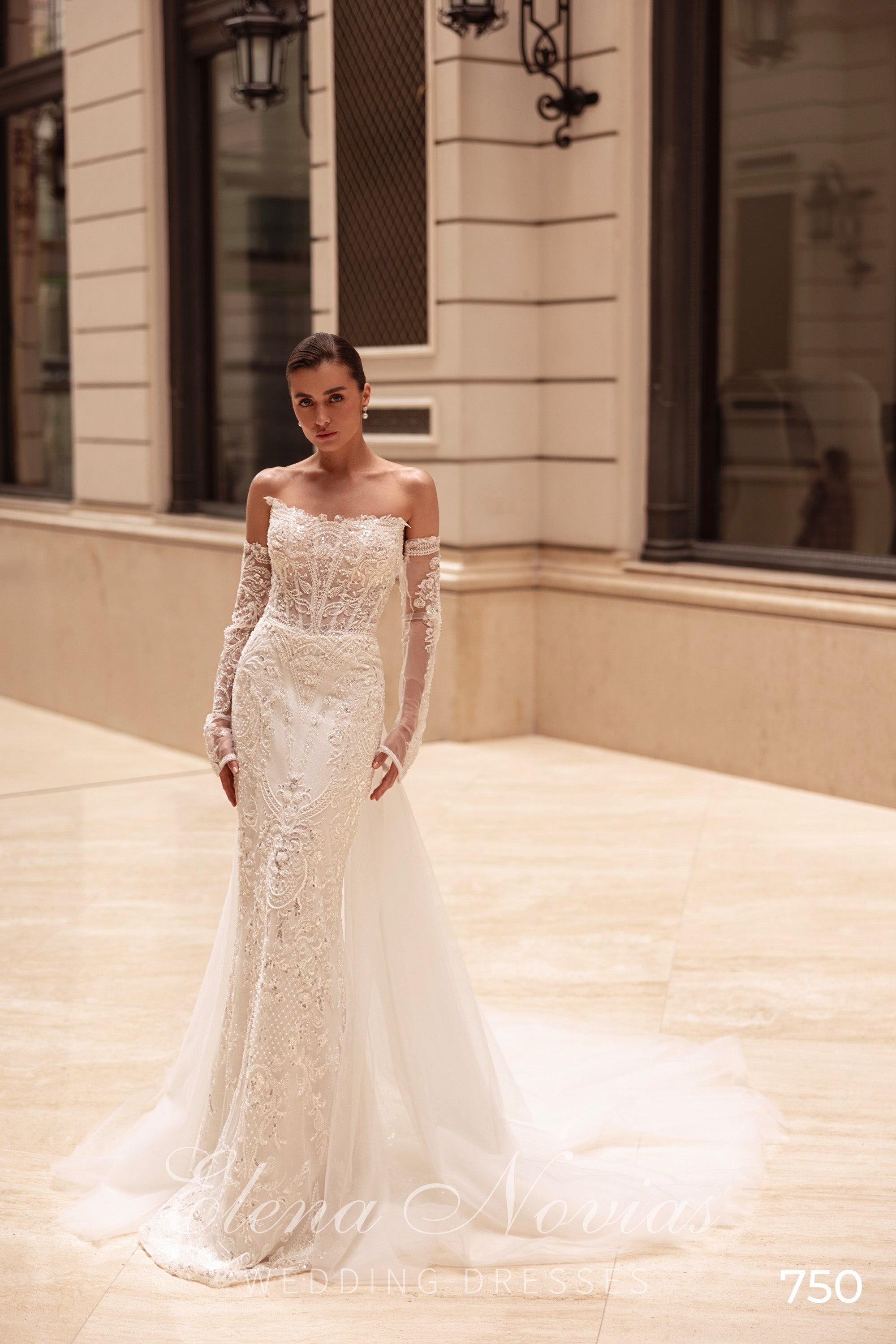 Ivory beaded lace mermaid wedding dress with long sheer sleeves and a sweeping train