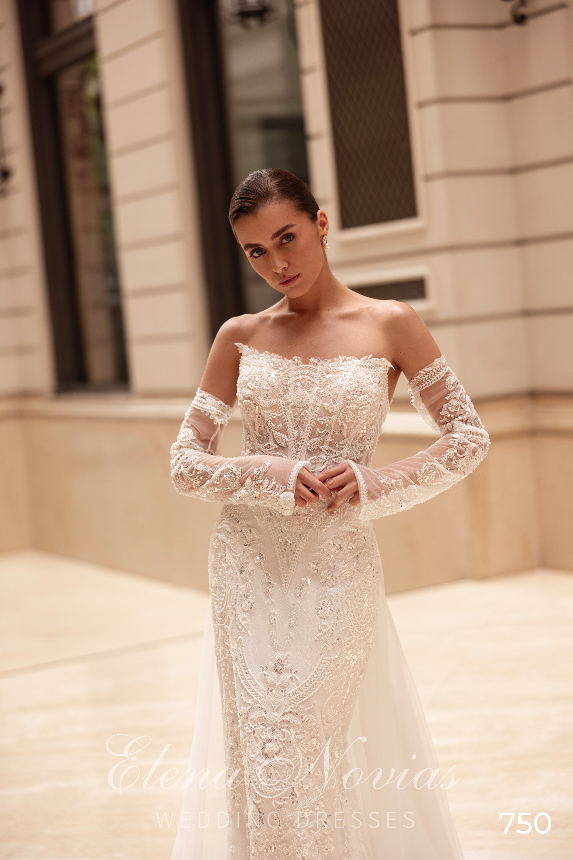 Ivory mermaid wedding dress with a sweetheart bodice, beaded lace, and long illusion sleeves