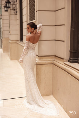 Low open back and fitted beaded lace silhouette on an ivory wedding dress with a long train