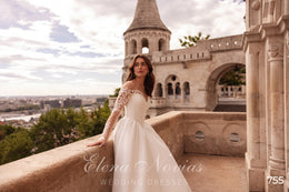 Ivory A-line wedding dress with long lace sleeves, fitted bodice, and a sweeping train shown in profile