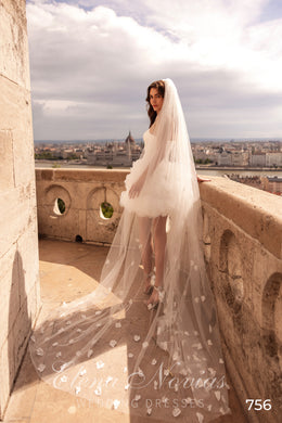 Strapless ivory wedding dress with a 3D floral mini skirt and long sheer veil with floral motifs
