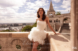 Strapless ivory wedding dress with a smooth fitted bodice and voluminous 3D floral mini skirt