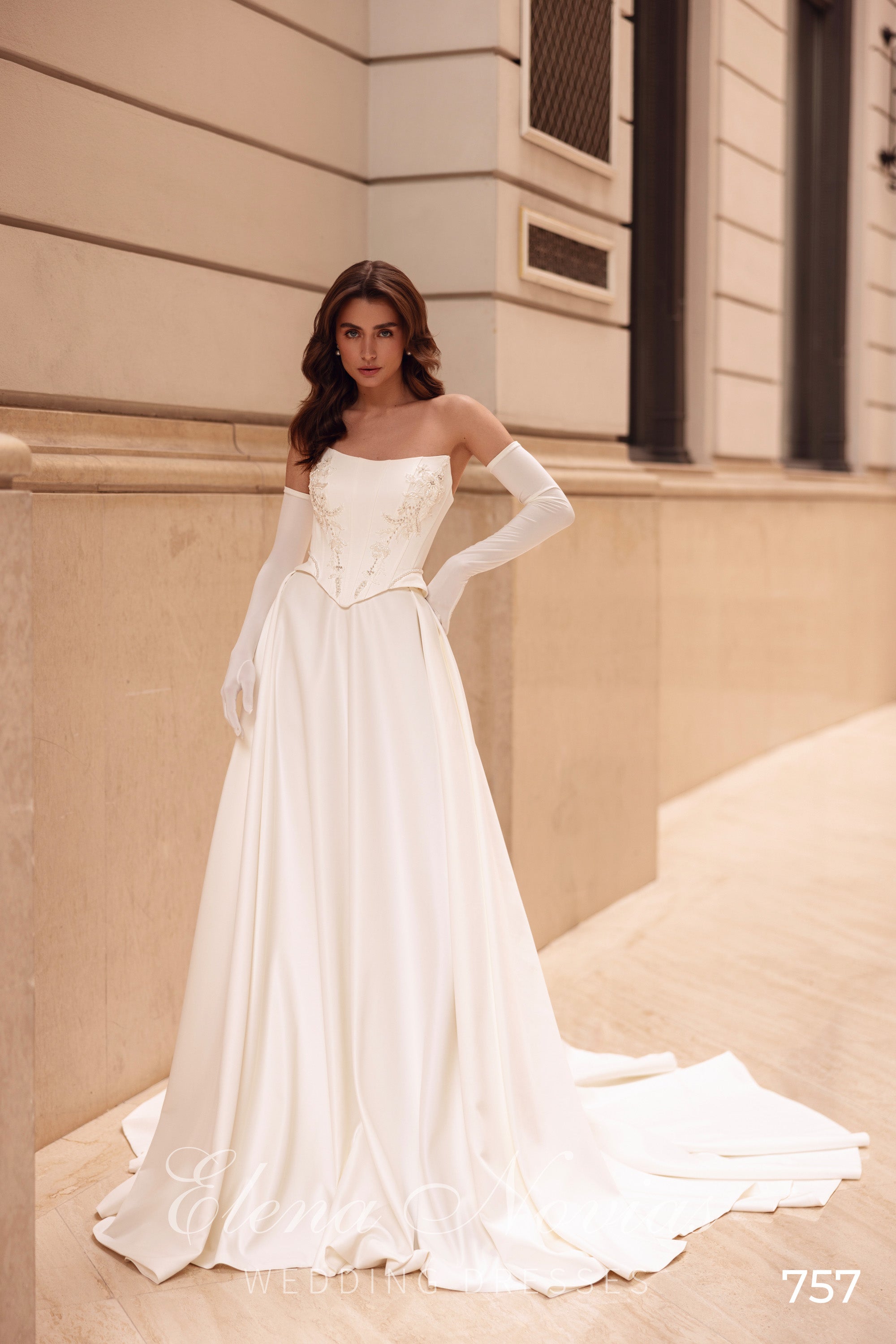 Ivory A-line wedding dress with a strapless floral corset bodice and sweeping satin train