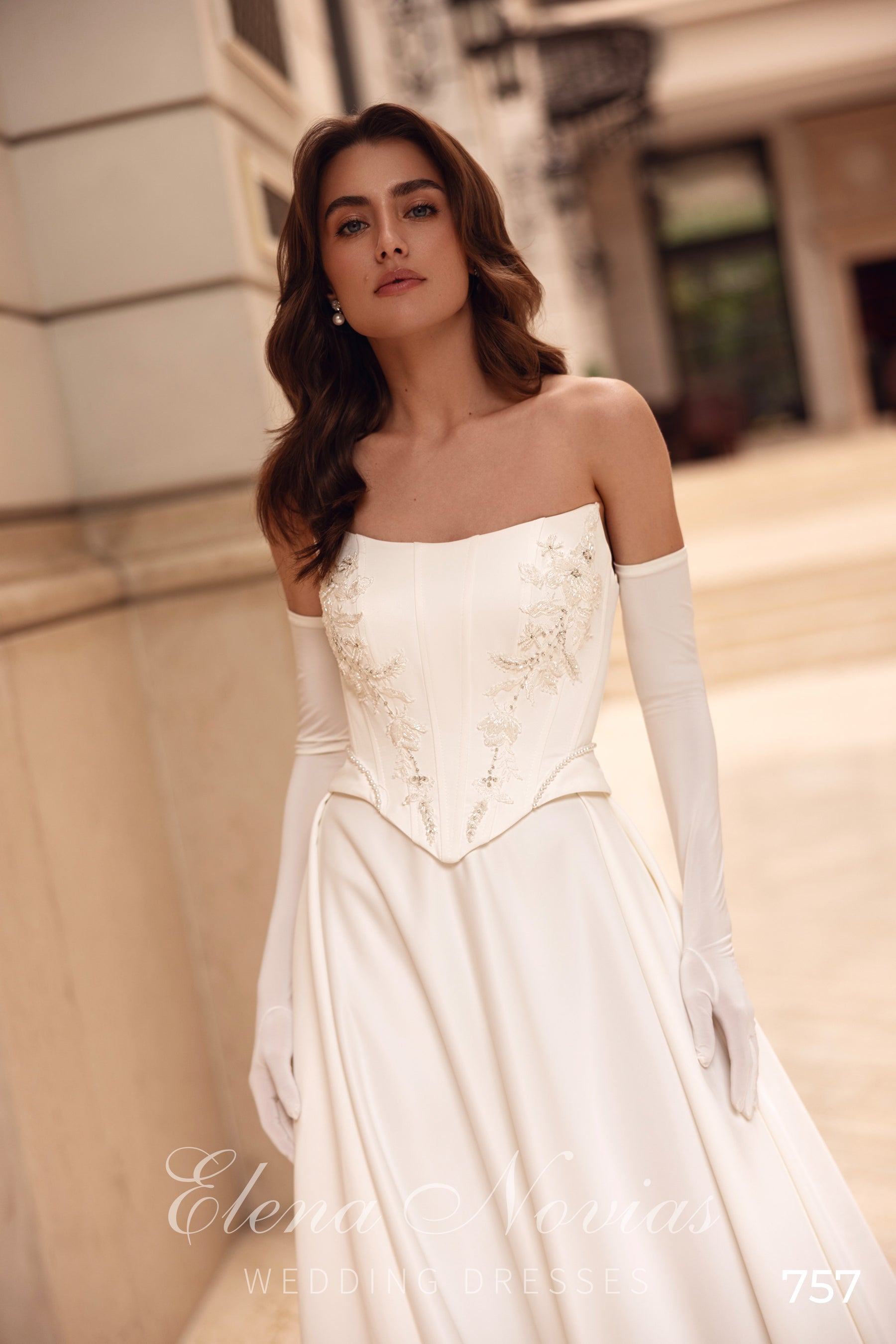 Close-up of the strapless wedding dress bodice with floral appliqués and a straight neckline
