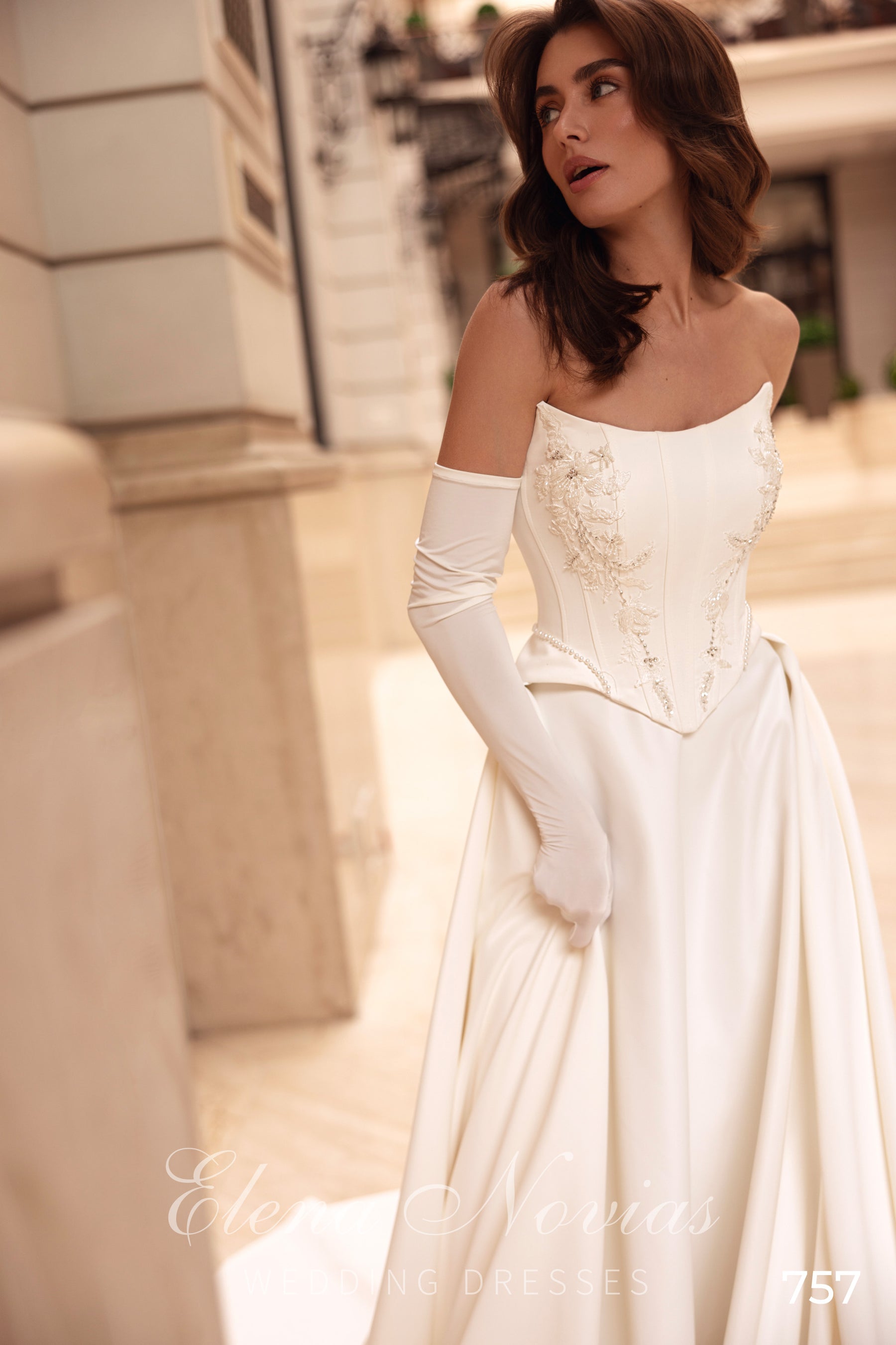 Ivory strapless wedding dress with floral detailing on the corset bodice and a full satin skirt