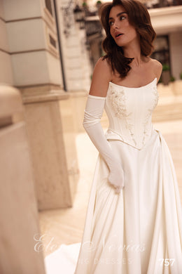Ivory strapless wedding dress with floral detailing on the corset bodice and a full satin skirt