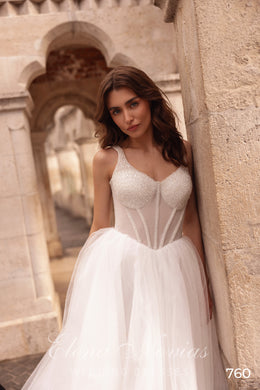 Close-up of a beaded sweetheart neckline and sheer corset bodice on an ivory wedding dress