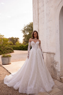 Ivory ball gown wedding dress with floral lace sleeves, beaded illusion neckline, and a sweeping train