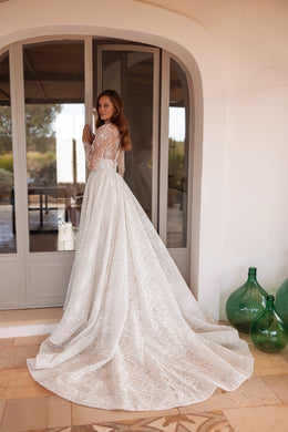 Detachable lace overskirt creates a voluminous long train on this ivory wedding dress