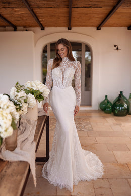 Ivory fitted wedding dress with a high illusion neckline, sheer floral lace sleeves, and a lace train