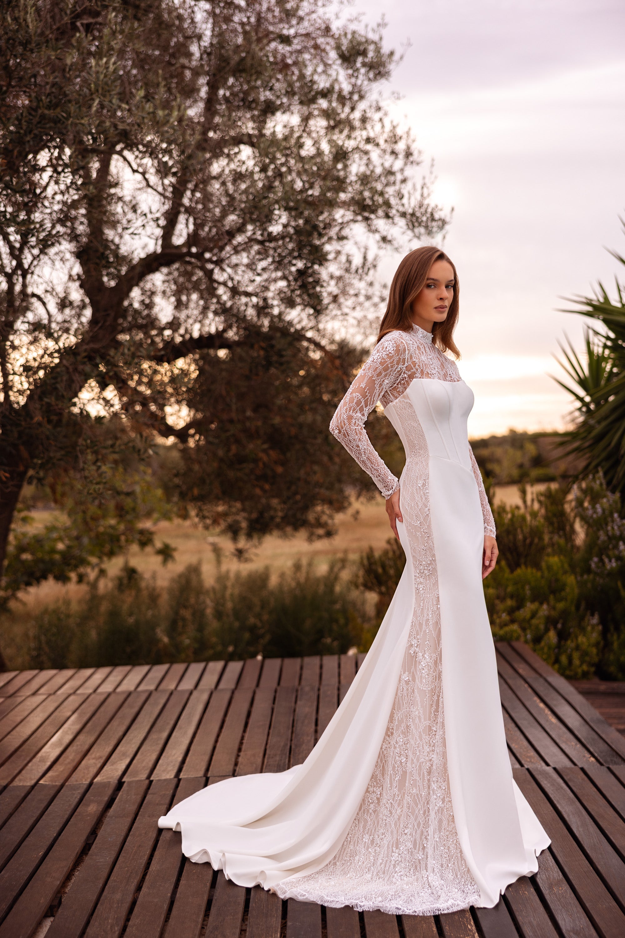 Ivory sheath wedding dress with fitted floral lace long sleeves, a square neckline, and lace train