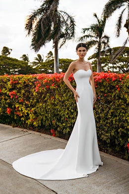 Strapless ivory mermaid wedding dress with a sweetheart neckline, smooth fitted skirt, and long sweeping train