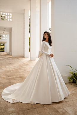 Ivory A-line wedding dress with long sleeves, a smooth bodice, and a sweeping train